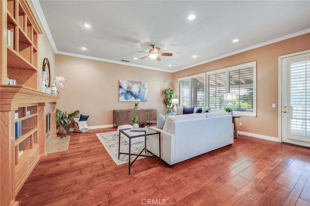 8911 Mustang Rd, Alta Loma, CA 91701 - living area with a ceiling fan, wood finished floors, healthy amount of natural light, recessed lighting, and crown molding
