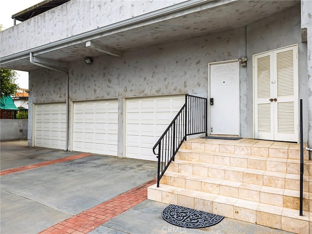 715 W Palm Ave, El Segundo, CA 90245 - property entrance with a garage, stucco siding, and driveway