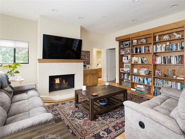 715 W Palm Ave, El Segundo, CA 90245 - living area featuring wood finished floors, a warm lit fireplace, and recessed lighting