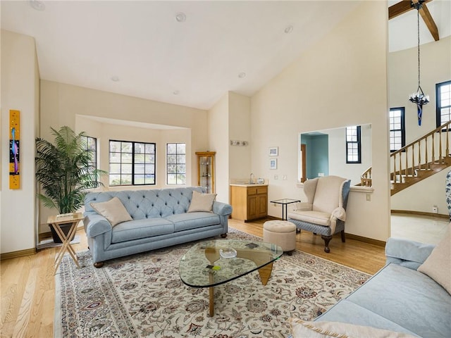 715 W Palm Ave, El Segundo, CA 90245 - living area featuring healthy amount of natural light, light wood finished floors, high vaulted ceiling, and stairs