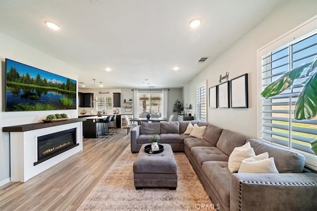 20909 Spring St, Riverside, CA 92507 - living area with light wood-type flooring, recessed lighting, and a glass covered fireplace