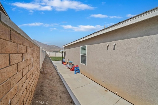 20909 Spring St, Riverside, CA 92507 - view of property exterior featuring a fenced backyard, stucco siding, and a mountain view