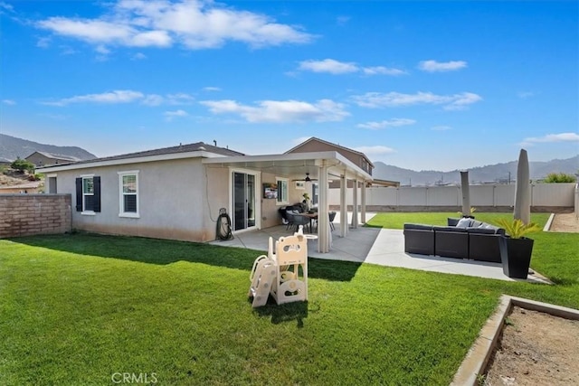 20909 Spring St, Riverside, CA 92507 - back of property with a fenced backyard, a patio area, stucco siding, and an outdoor living space