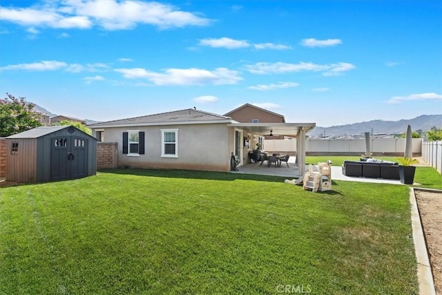 20909 Spring St, Riverside, CA 92507 - back of house with a patio, a fenced backyard, a storage unit, stucco siding, and an outdoor hangout area