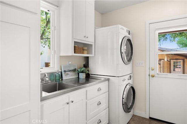 1013 Arbutus Ave, Chico, CA 95926 - laundry room with stacked washing machine and dryer, cabinet space, and tile patterned flooring