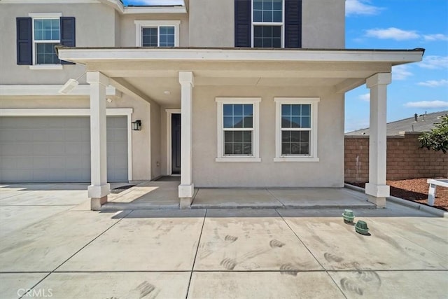20697 Bison Mesa Rd, Riverside, CA 92507 - view of exterior entry featuring stucco siding and a garage