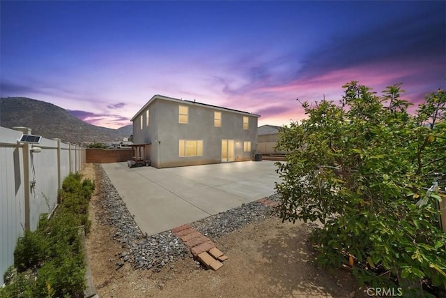 20697 Bison Mesa Rd, Riverside, CA 92507 - rear view of property with a patio, a fenced backyard, stucco siding, and a mountain view