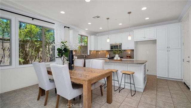 233 Bright Poppy, Irvine, CA 92618 - dining space featuring light tile patterned flooring, recessed lighting, and crown molding