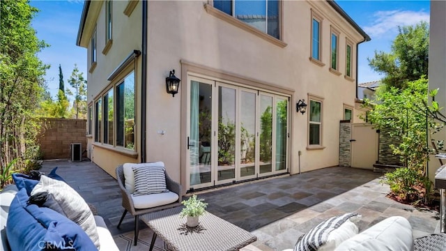 233 Bright Poppy, Irvine, CA 92618 - rear view of house featuring stucco siding, a patio area, and an outdoor hangout area