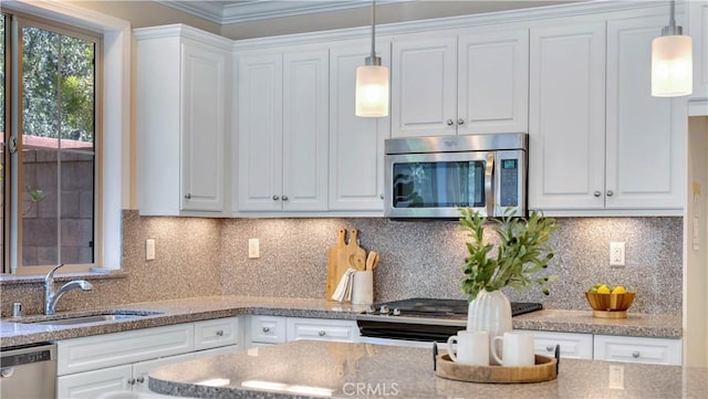 233 Bright Poppy, Irvine, CA 92618 - kitchen with appliances with stainless steel finishes, white cabinets, decorative light fixtures, light stone countertops, and crown molding