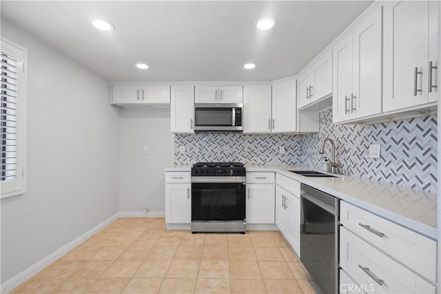 8211 Winnetka Ave Unit 201, Winnetka, CA 91306 - kitchen with appliances with stainless steel finishes, decorative backsplash, light countertops, white cabinets, and recessed lighting