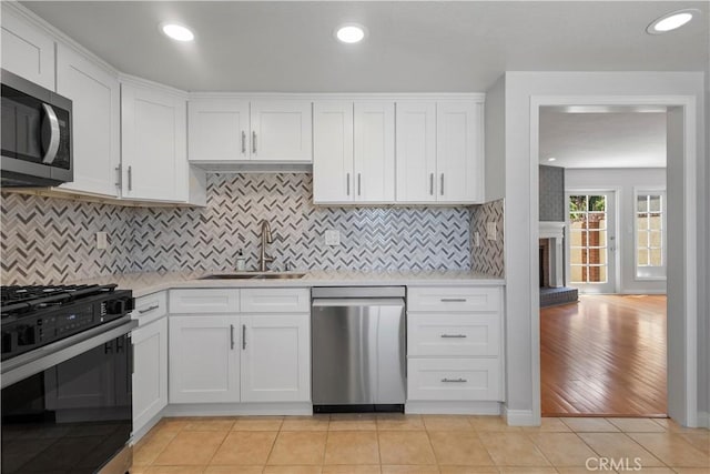 8211 Winnetka Ave Unit 201, Winnetka, CA 91306 - kitchen with stainless steel appliances, light countertops, white cabinetry, tasteful backsplash, and recessed lighting