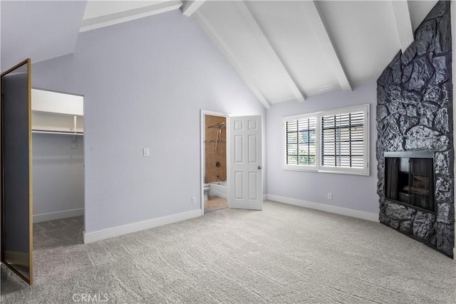 8211 Winnetka Ave Unit 201, Winnetka, CA 91306 - unfurnished living room featuring beamed ceiling, carpet flooring, a fireplace, and high vaulted ceiling