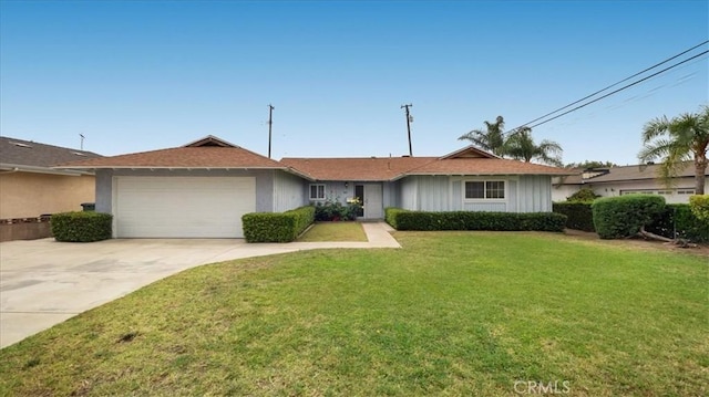 5007 Walnut Ave, Chino, CA 91710 - ranch-style house featuring a garage, a front yard, concrete driveway, and board and batten siding