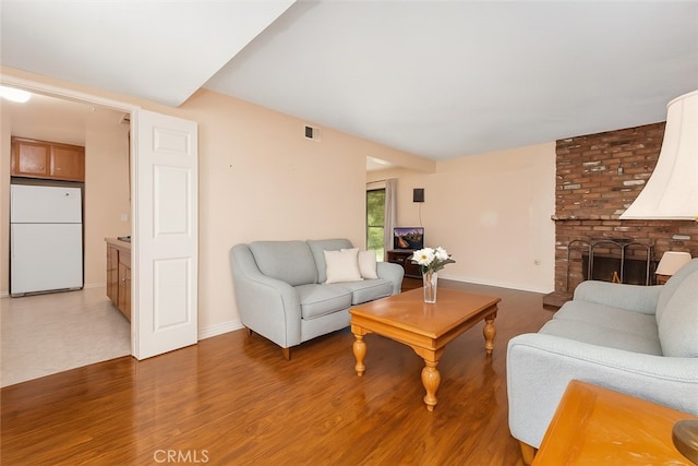 5007 Walnut Ave, Chino, CA 91710 - living area with a brick fireplace and light wood finished floors