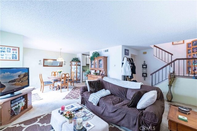 1363 San Simeon Ct Unit 7, Ventura, CA 93003 - carpeted living area with stairway and a textured ceiling