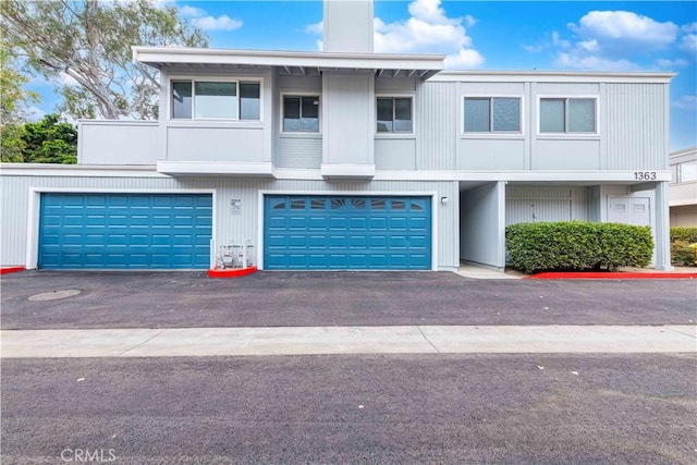 1363 San Simeon Ct Unit 7, Ventura, CA 93003 - townhome / multi-family property with an attached garage, a chimney, and asphalt driveway