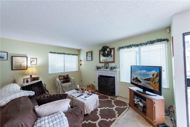 1363 San Simeon Ct Unit 7, Ventura, CA 93003 - living area with a textured ceiling, a fireplace with flush hearth, healthy amount of natural light, and carpet floors