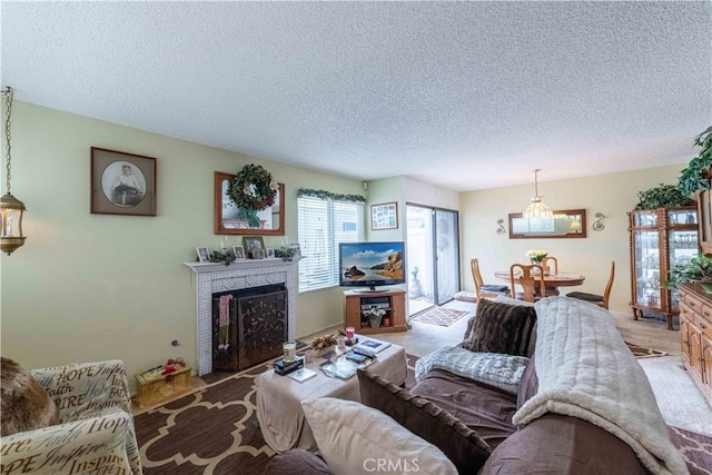 1363 San Simeon Ct Unit 7, Ventura, CA 93003 - living room with a textured ceiling, light colored carpet, and a fireplace with flush hearth