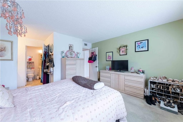 1363 San Simeon Ct Unit 7, Ventura, CA 93003 - bedroom featuring a textured ceiling, carpet flooring, and ensuite bathroom