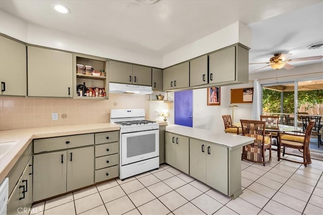 8160 Cholla Ave, Yucca Valley, CA 92284 - kitchen with white range with gas stovetop, under cabinet range hood, a peninsula, open shelves, and light countertops