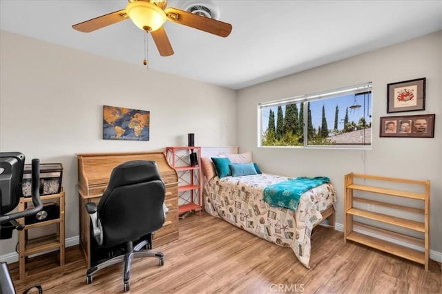 8160 Cholla Ave, Yucca Valley, CA 92284 - bedroom featuring wood finished floors, a ceiling fan, and an office area