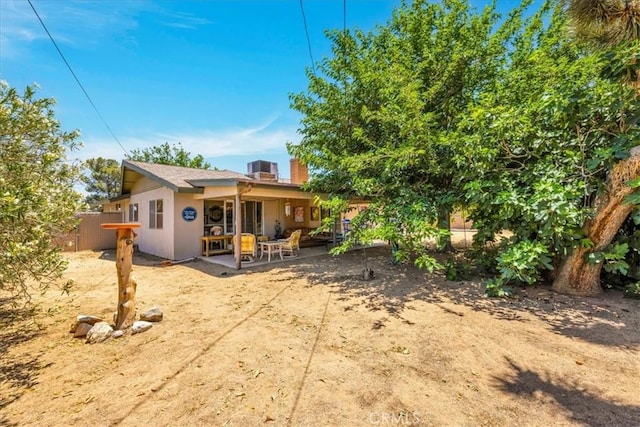 8160 Cholla Ave, Yucca Valley, CA 92284 - back of house featuring a patio and a chimney