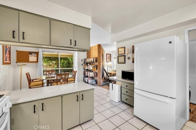 8160 Cholla Ave, Yucca Valley, CA 92284 - kitchen featuring freestanding refrigerator, light countertops, light tile patterned floors, and stove