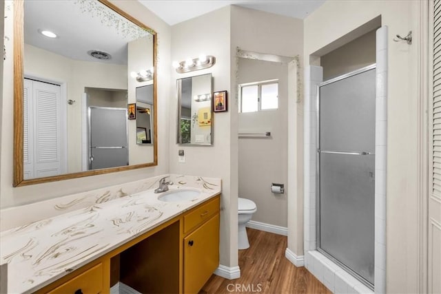 8160 Cholla Ave, Yucca Valley, CA 92284 - full bathroom with a closet, vanity, a shower stall, and wood finished floors