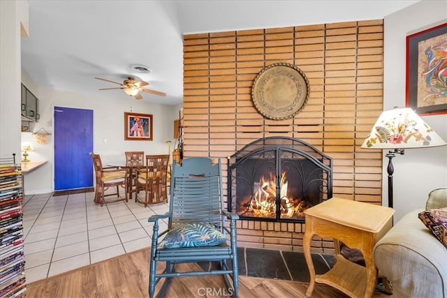 8160 Cholla Ave, Yucca Valley, CA 92284 - tiled living room with a fireplace and a ceiling fan