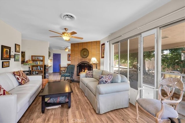 8160 Cholla Ave, Yucca Valley, CA 92284 - living room with ceiling fan, wood finished floors, and a fireplace