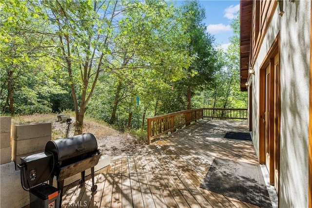 77 Park Dr, Running Springs, CA 92382 - wooden terrace with a grill and view of wooded area