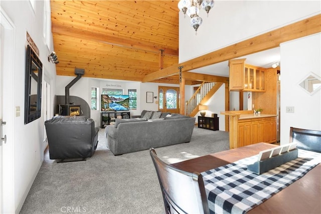 77 Park Dr, Running Springs, CA 92382 - carpeted dining area featuring a wood stove, stairs, and wooden ceiling