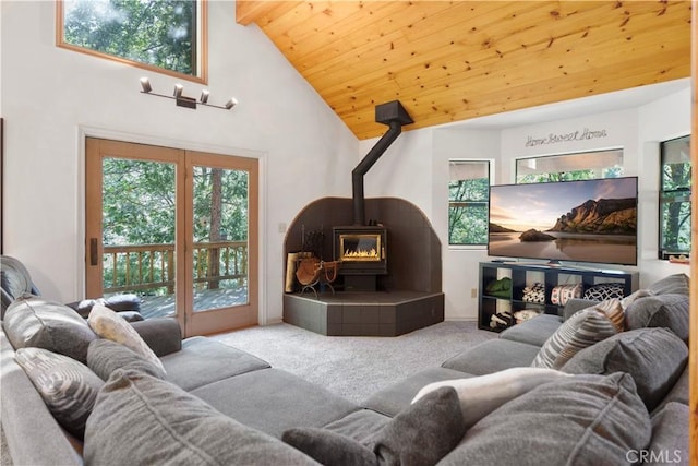 77 Park Dr, Running Springs, CA 92382 - carpeted living room featuring a wood stove, a wood ceiling with exposed beams, and high vaulted ceiling