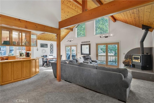 77 Park Dr, Running Springs, CA 92382 - living room featuring a wood stove, light colored carpet, high vaulted ceiling, and a wooden ceiling with exposed beams
