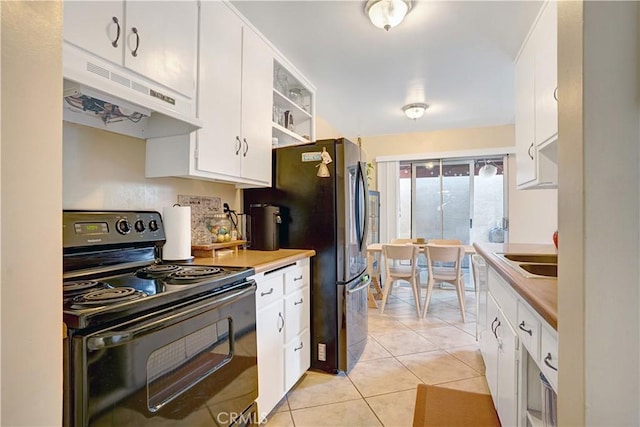 4743 Jackson St Unit 69, Riverside, CA 92503 - kitchen featuring black electric range, under cabinet range hood, white cabinets, light tile patterned flooring, and freestanding refrigerator