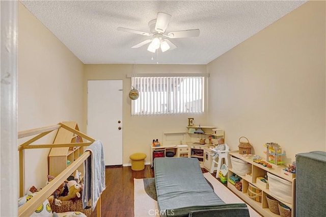 4743 Jackson St Unit 69, Riverside, CA 92503 - bedroom featuring a textured ceiling, wood finished floors, and a ceiling fan