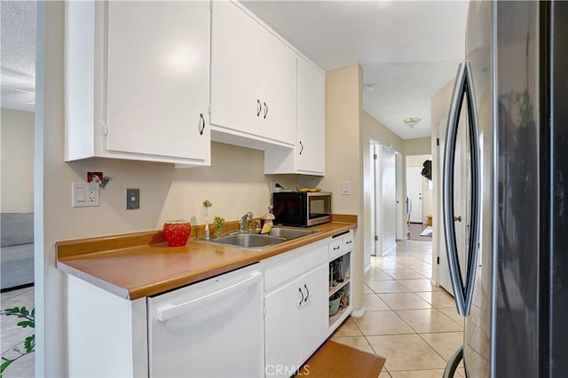 4743 Jackson St Unit 69, Riverside, CA 92503 - kitchen featuring stainless steel appliances, white cabinets, light tile patterned floors, and light countertops