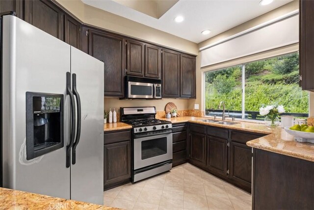 25066 El Carrizo, Laguna Niguel, CA 92677 - kitchen featuring stainless steel appliances, recessed lighting, dark brown cabinets, light tile patterned flooring, and light stone countertops