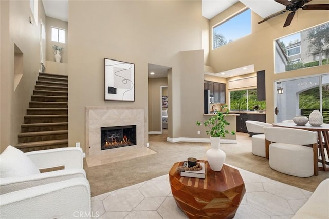 25066 El Carrizo, Laguna Niguel, CA 92677 - living room featuring light carpet, healthy amount of natural light, a high ceiling, a fireplace, and ceiling fan