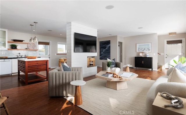 29 Surfside Ave Unit B, Surfside, CA 90743 - living area with dark wood-style flooring and a fireplace