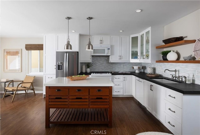 29 Surfside Ave Unit B, Surfside, CA 90743 - kitchen featuring white microwave, stainless steel fridge with ice dispenser, open shelves, tasteful backsplash, and white cabinetry