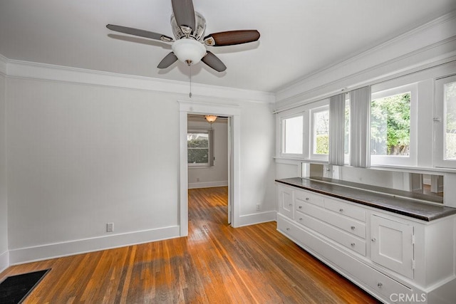 315 E Randolph St, Glendale, CA 91207 - kitchen featuring dark countertops, a ceiling fan, wood finished floors, white cabinets, and crown molding