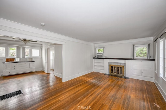 315 E Randolph St, Glendale, CA 91207 - unfurnished living room featuring wood finished floors, crown molding, a fireplace, healthy amount of natural light, and a ceiling fan