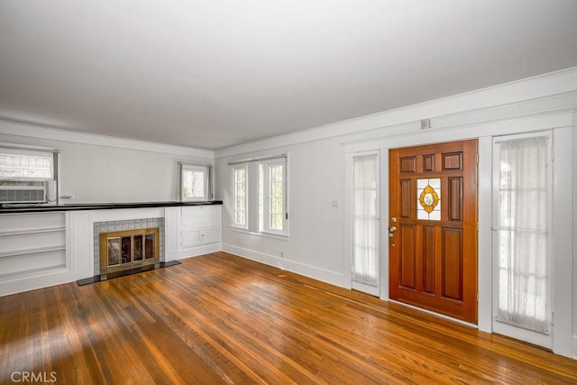 315 E Randolph St, Glendale, CA 91207 - entrance foyer featuring dark wood-style floors, ornamental molding, healthy amount of natural light, a glass covered fireplace, and cooling unit