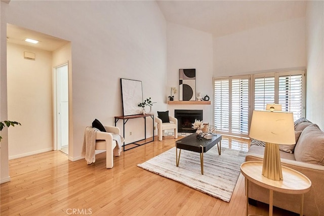 4280 Via Arbolada Unit 338, Los Angeles, CA 90042 - living area with wood-type flooring, a high ceiling, and a fireplace