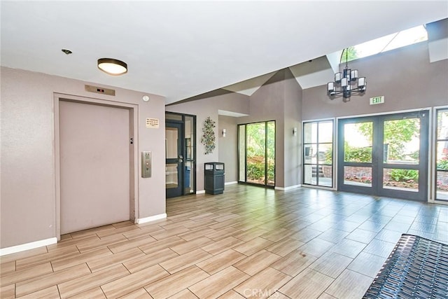 4280 Via Arbolada Unit 338, Los Angeles, CA 90042 - unfurnished living room featuring a chandelier, wood tiled floors, and elevator