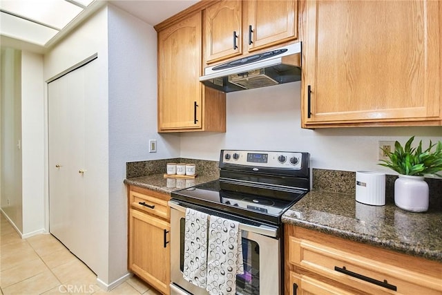4280 Via Arbolada Unit 338, Los Angeles, CA 90042 - kitchen featuring stainless steel electric range, under cabinet range hood, light tile patterned floors, and dark stone countertops