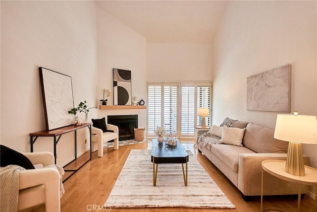 4280 Via Arbolada Unit 338, Los Angeles, CA 90042 - living area featuring a high ceiling, light wood finished floors, and a fireplace with flush hearth