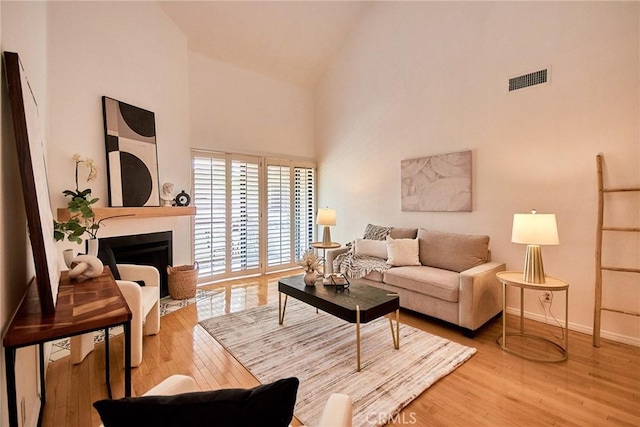 4280 Via Arbolada Unit 338, Los Angeles, CA 90042 - living area with high vaulted ceiling, wood finished floors, and a fireplace
